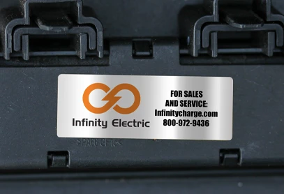 Strong adhesive sticker made from Vinyl Reflective 7.5 mil material, applied to a black surface. Features a metallic finish with custom branding for Infinity Electric, ensuring long-lasting durability and high visibility.