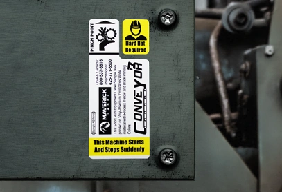 Vinyl Premium 2-mil strong adhesive sticker applied to industrial equipment. The durable label includes safety warnings, brand details, and high-contrast text for clear visibility in tough environments.